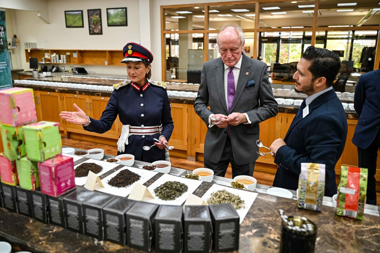 A group of people tasting tea in an office setting