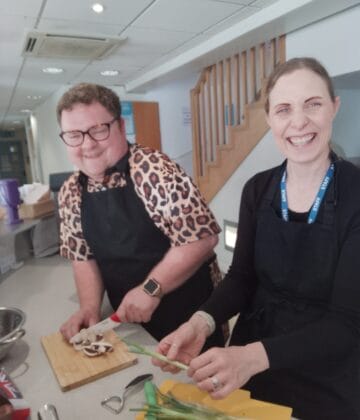 Pam and Callum preparing a meal together.