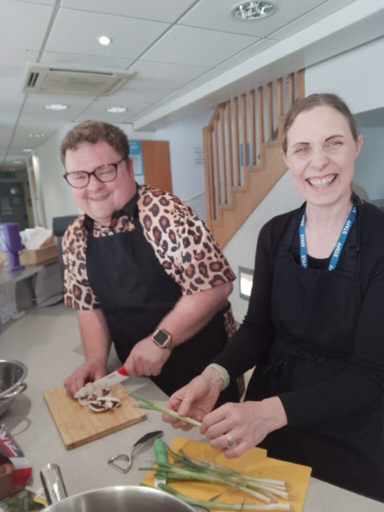 Pam and Callum preparing a meal together.